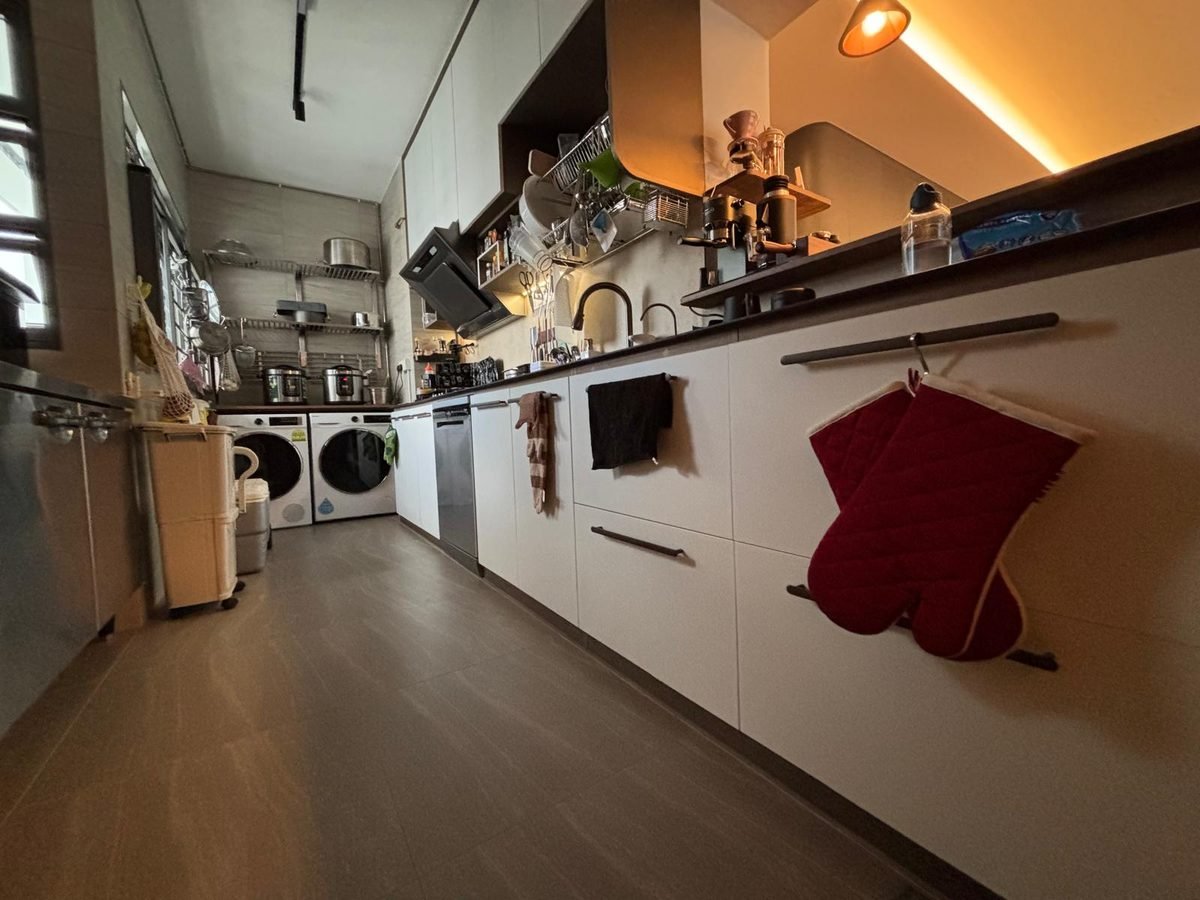 Long kitchen with white aluminium cabinets and under-cabinet lighting