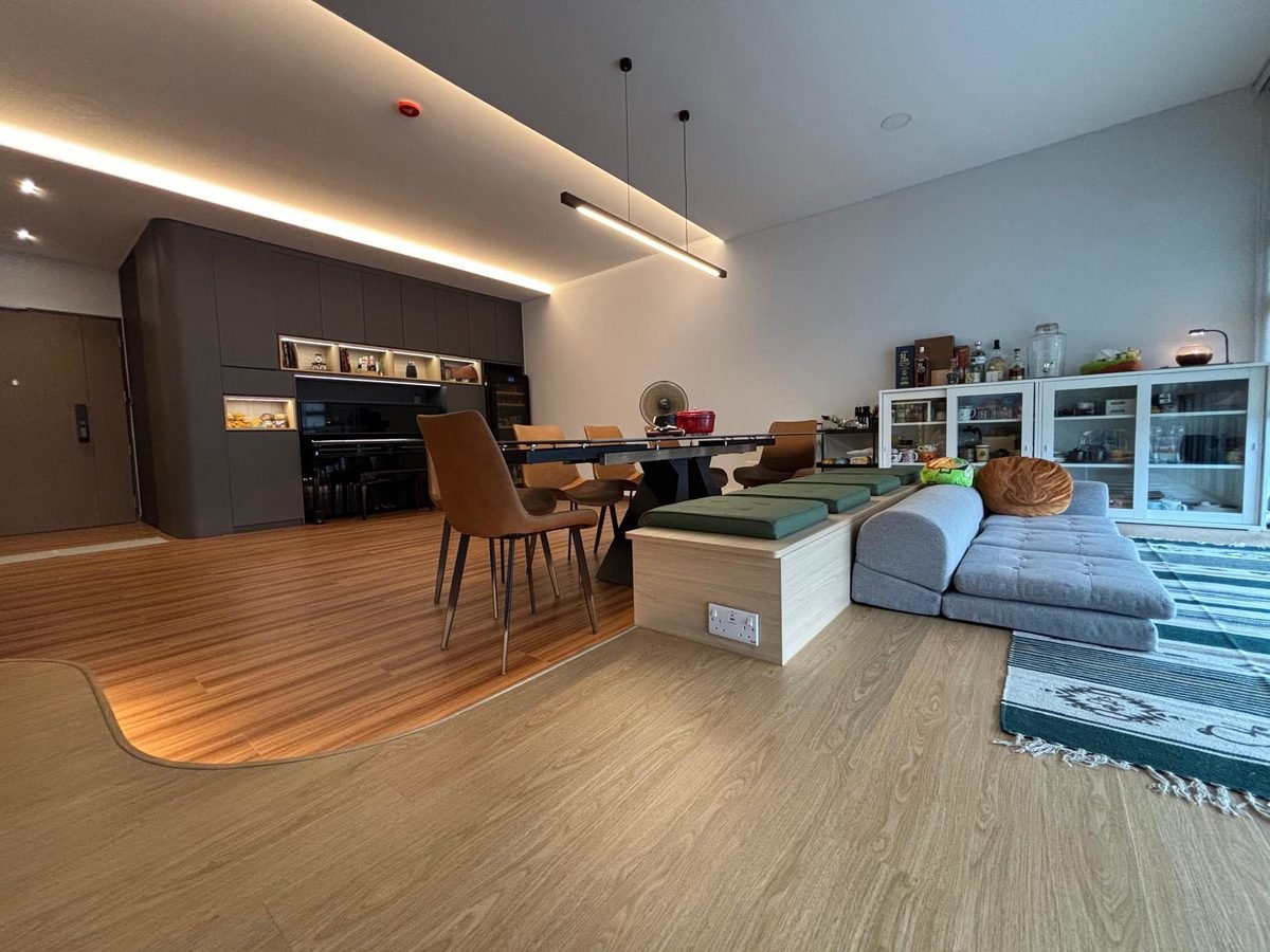 Open-plan living and dining area with built-in dark carpentry wall